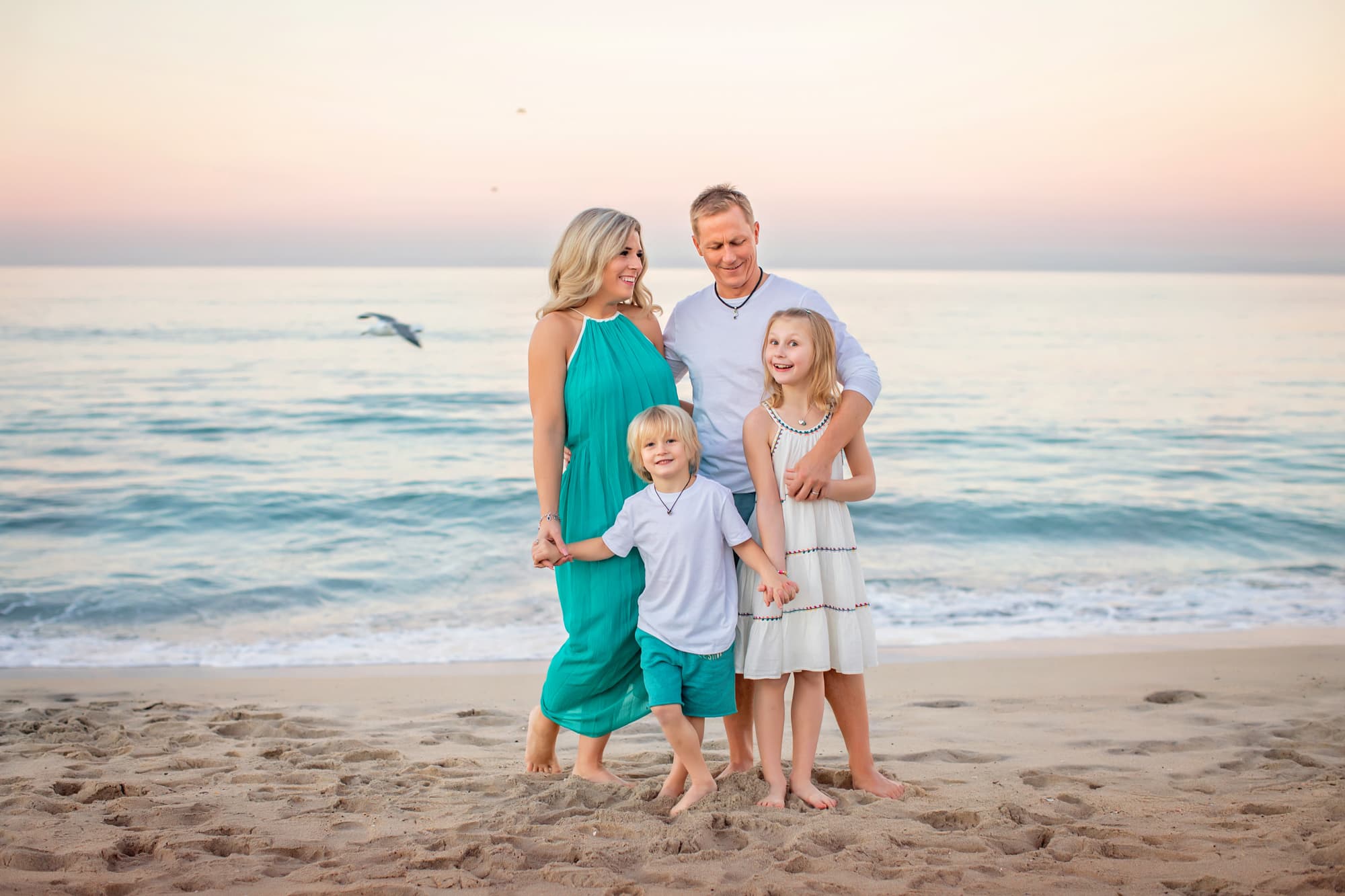Carlsbad Beach Photographers with family of four at sunrise