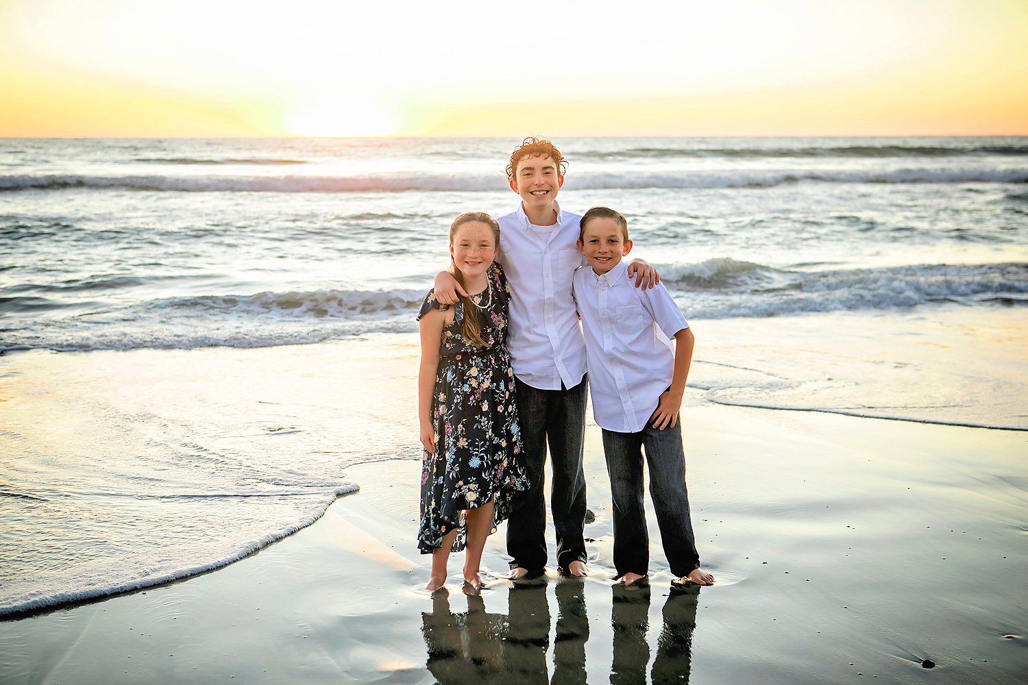Photo by Carlsbad Family Beach Photographer. Photo may be of 3 people standing outdoors.