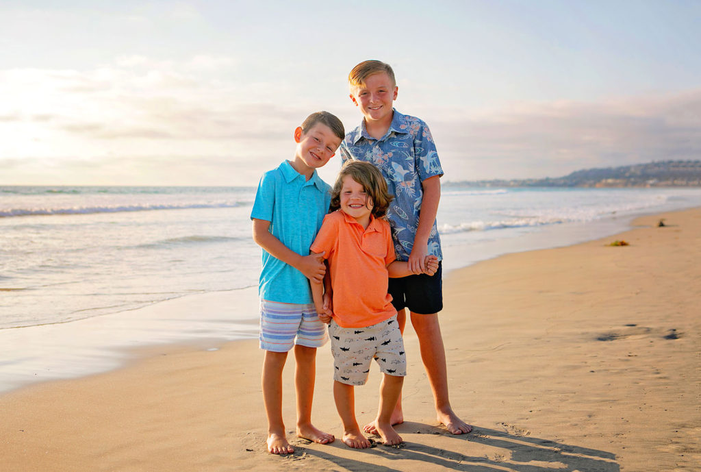 Photography by Childrens Beach photographer. Photo is of 5 people standing outdoors. 