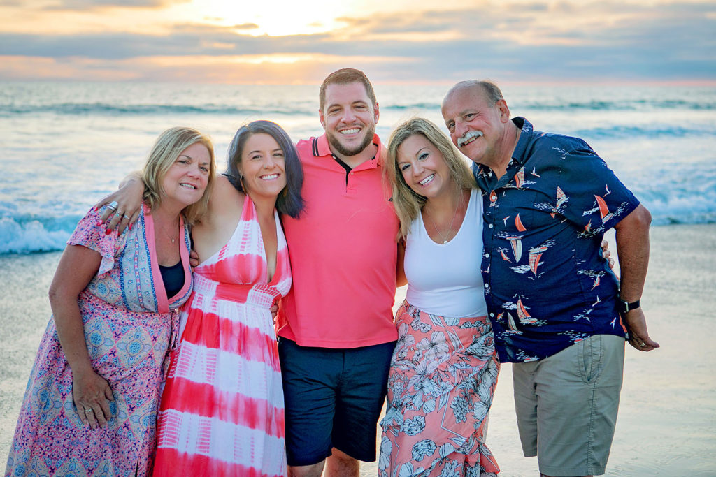 Photography by San Diego family Beach photographer. Photo is of 5 people standing outdoors. 