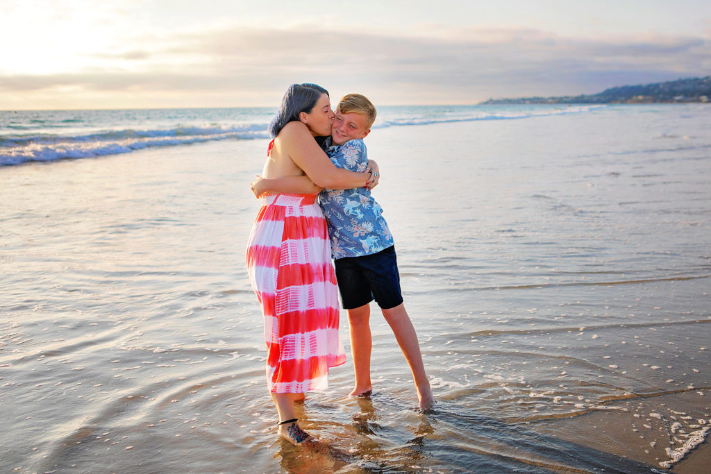 Photography by San diego Beach photographer. Photo is of 2 people standing outdoors. 