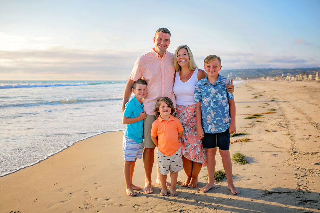 Photography by family Beach photographer. Photo is of 5 people standing outdoors. 