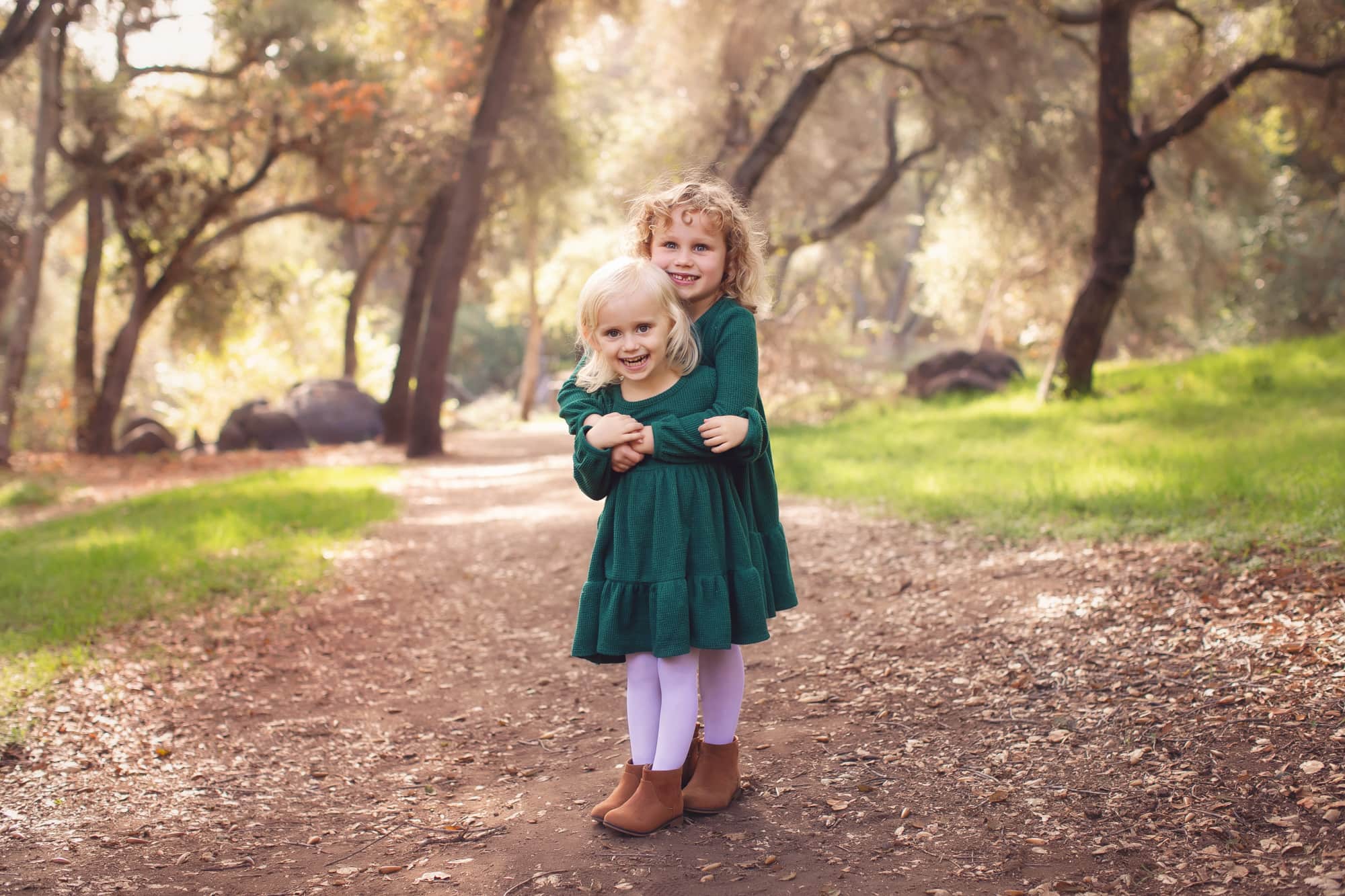Sisters hugging in Felicita Park Escondido for their photo session with Kristin Rachelle Photography