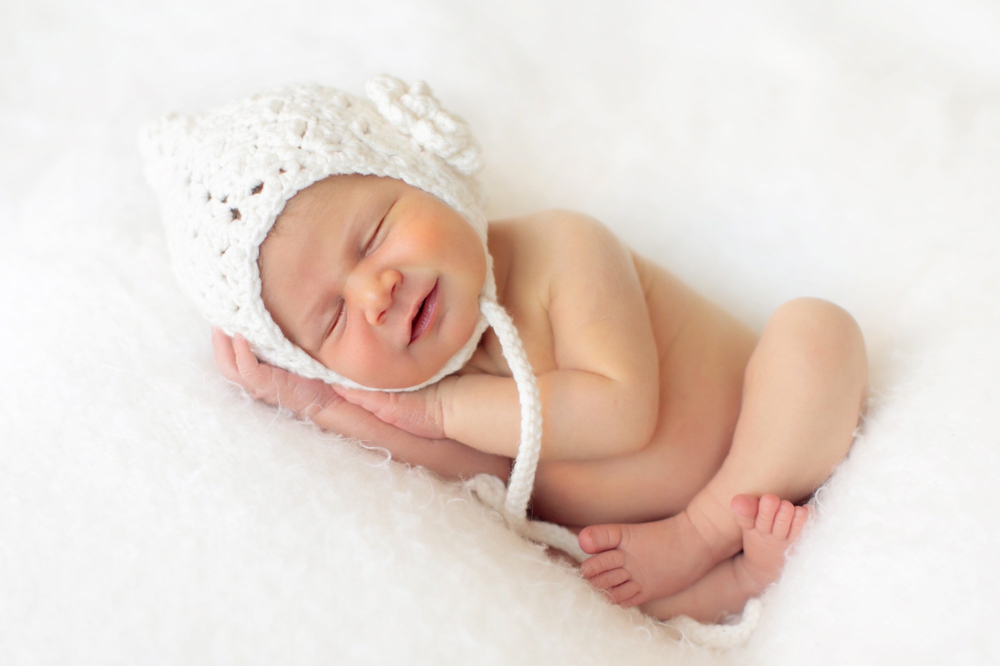 Newborn Studio Photography of infant girl smiling