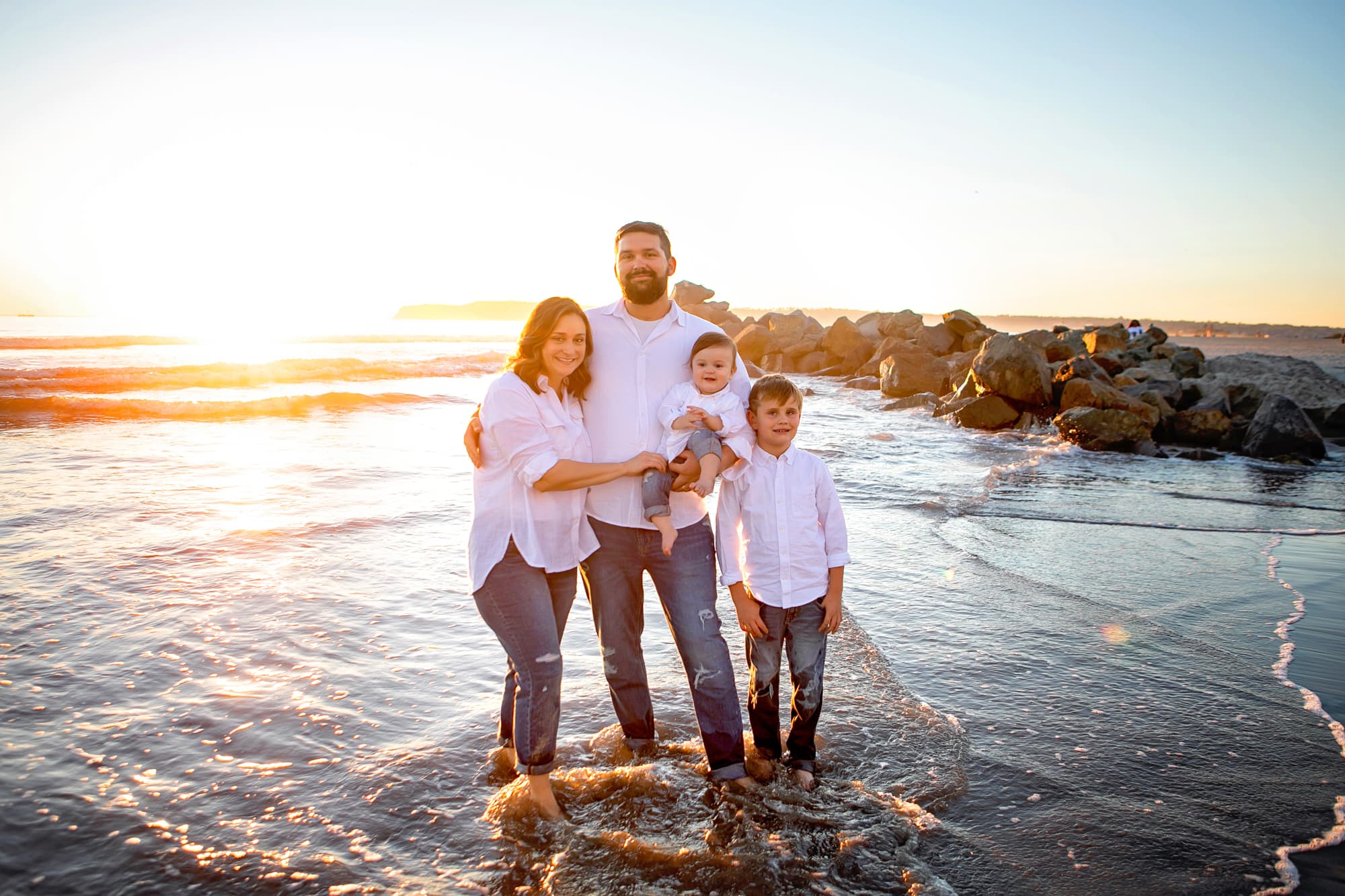 Family at Hotel Del Coronado beach at sunset 